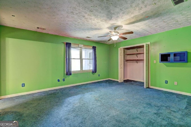 unfurnished bedroom with carpet flooring, ceiling fan, a closet, and a textured ceiling