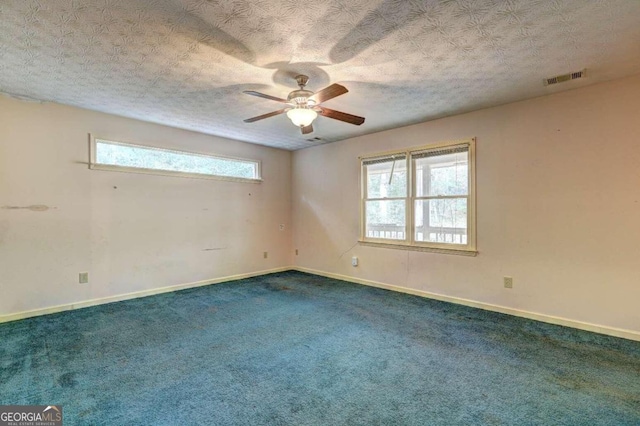 unfurnished room featuring carpet flooring, ceiling fan, and a textured ceiling