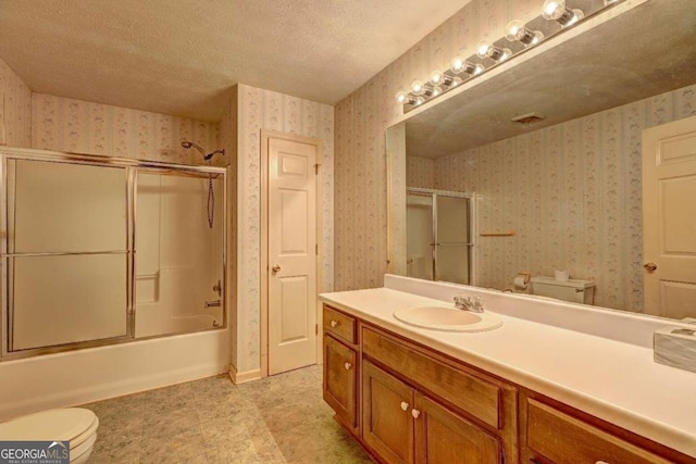 full bathroom featuring enclosed tub / shower combo, tile patterned floors, a textured ceiling, toilet, and vanity