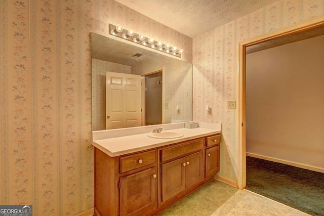 bathroom featuring vanity and a textured ceiling