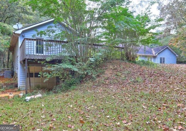 exterior space featuring central air condition unit and a deck