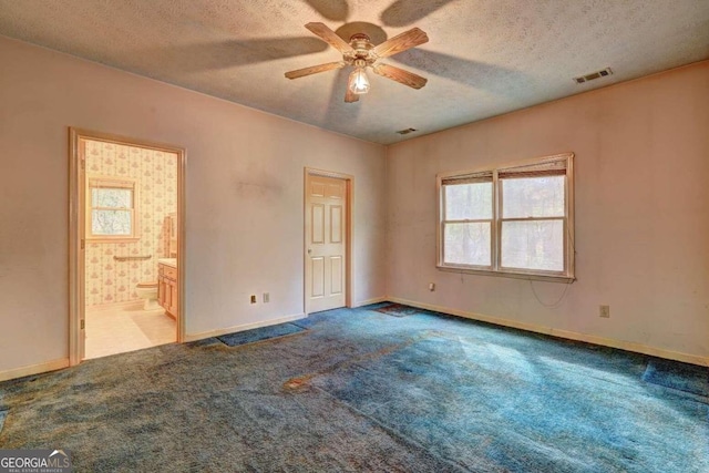 unfurnished room featuring a textured ceiling, light colored carpet, and ceiling fan