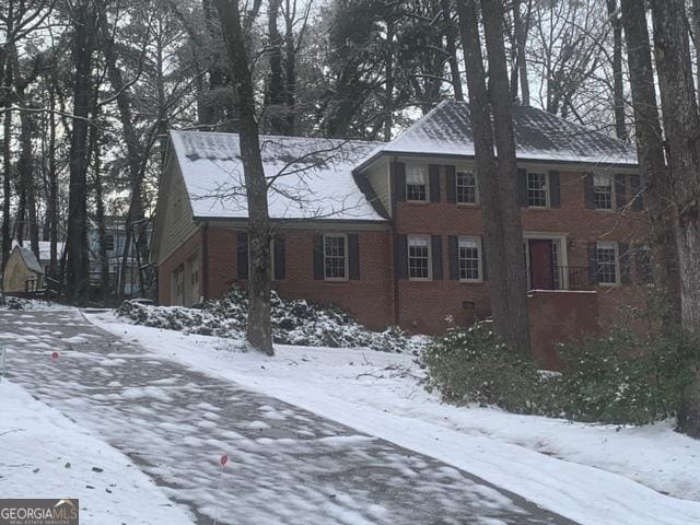 view of snowy exterior featuring a garage