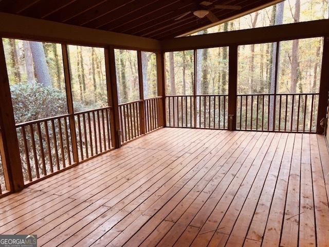 unfurnished sunroom featuring vaulted ceiling