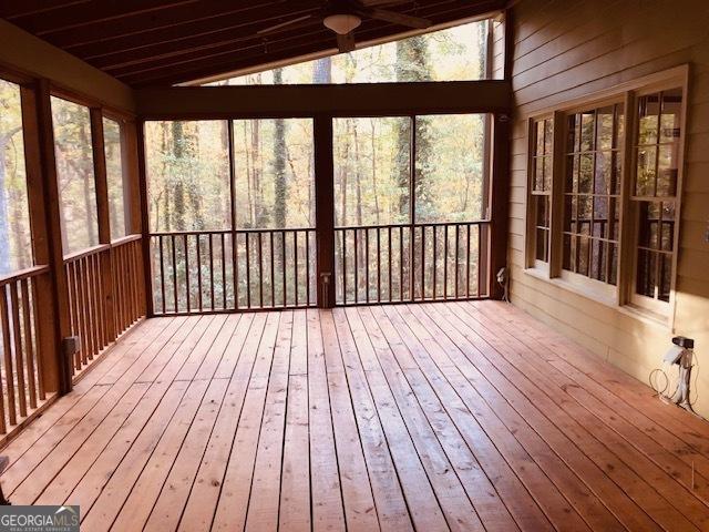 unfurnished sunroom with vaulted ceiling and wood ceiling