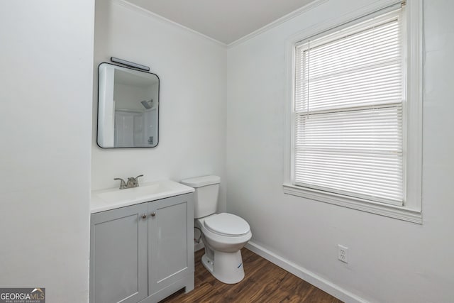 bathroom with hardwood / wood-style floors, vanity, toilet, and crown molding