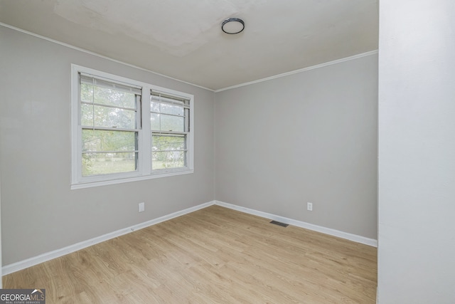 unfurnished room with light hardwood / wood-style floors and ornamental molding