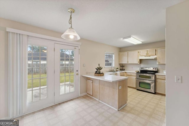 kitchen featuring kitchen peninsula, pendant lighting, plenty of natural light, and stainless steel electric range