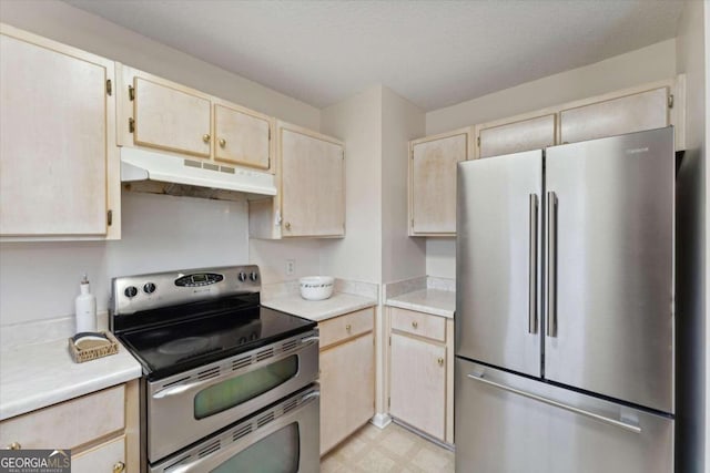 kitchen with light brown cabinets and appliances with stainless steel finishes