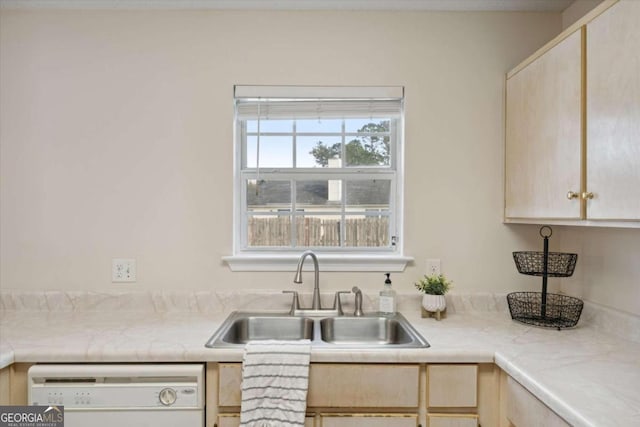 kitchen featuring light brown cabinets, white dishwasher, and sink