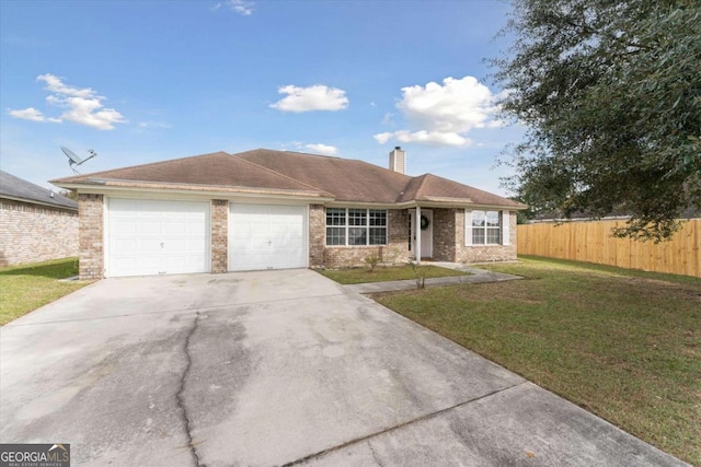 ranch-style house featuring a front yard and a garage