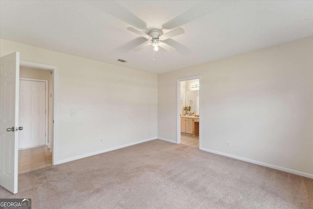 carpeted spare room with ceiling fan