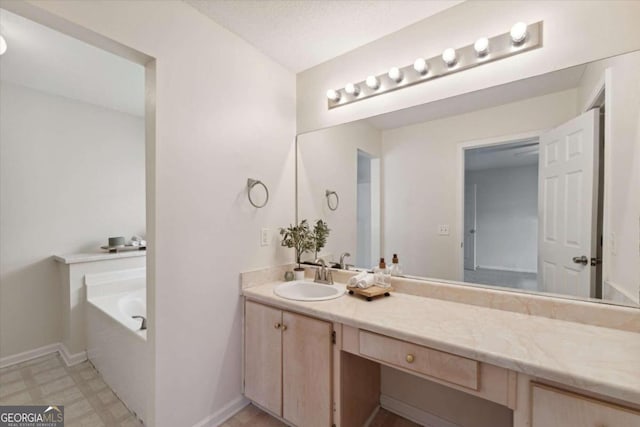 bathroom with vanity and a bath