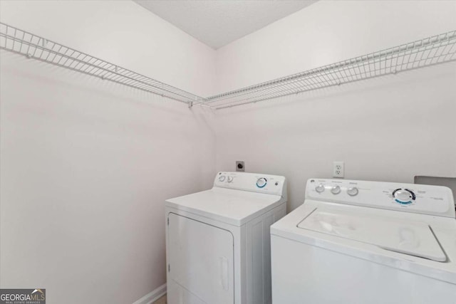 laundry area featuring washing machine and clothes dryer