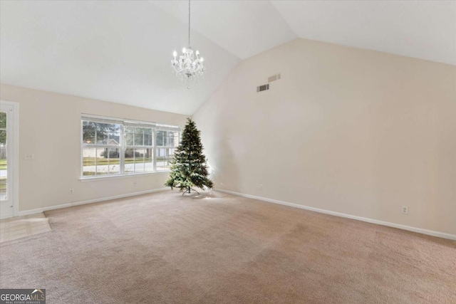 unfurnished living room featuring carpet floors, high vaulted ceiling, and a chandelier