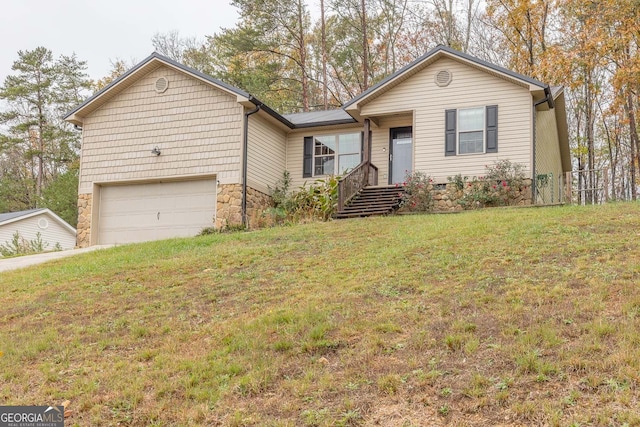 ranch-style home featuring a front lawn and a garage