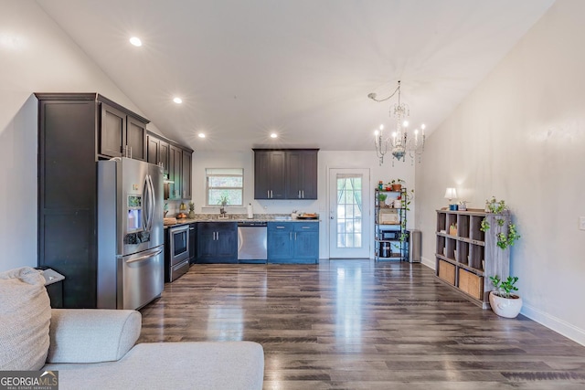 kitchen featuring stainless steel appliances, dark hardwood / wood-style floors, vaulted ceiling, and dark brown cabinets