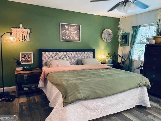 bedroom with hardwood / wood-style floors and ceiling fan