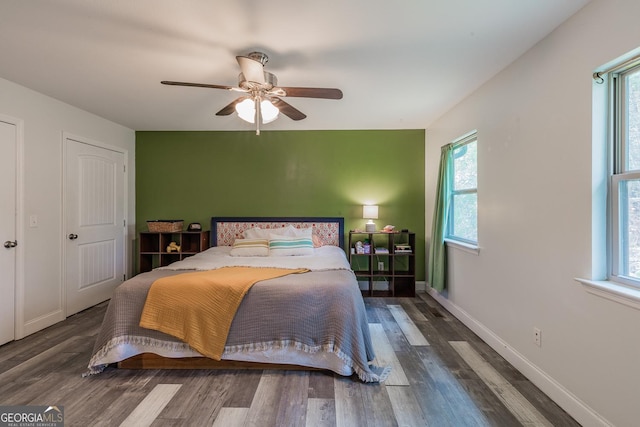 bedroom featuring ceiling fan and dark hardwood / wood-style flooring