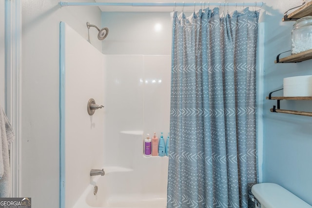 bathroom with shower / tub combo and toilet