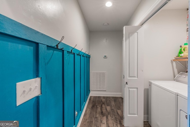 washroom with dark wood-type flooring and washer and dryer