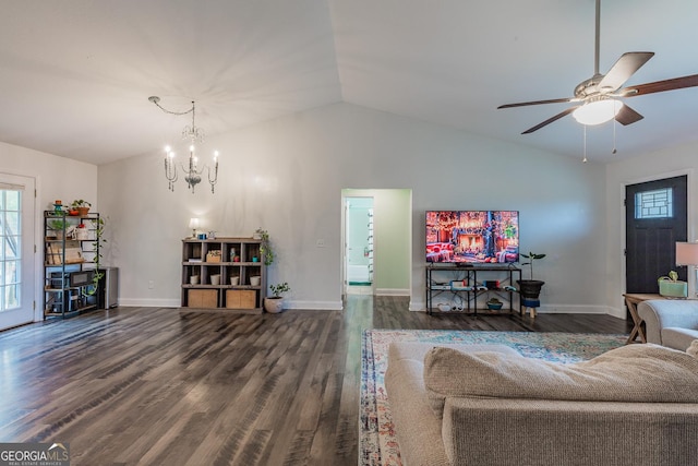 living room featuring dark wood-type flooring, lofted ceiling, a healthy amount of sunlight, and ceiling fan with notable chandelier