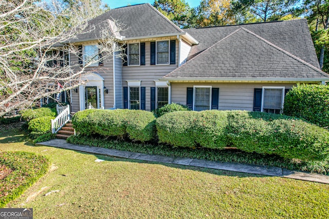 colonial home with a front lawn