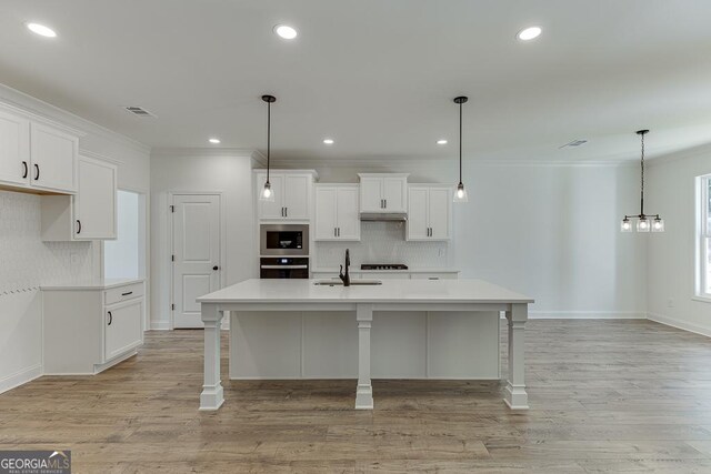 2198 Old Swimming Pool Rd, Jefferson, GA 30549 - kitchen featuring tasteful backsplash, a sink, light countertops, stainless steel microwave, and black oven