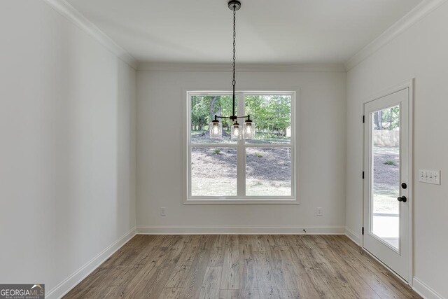2198 Old Swimming Pool Rd, Jefferson, GA 30549 - unfurnished dining area with crown molding, a chandelier, wood finished floors, and plenty of natural light