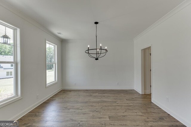 2198 Old Swimming Pool Rd, Jefferson, GA 30549 - unfurnished dining area with baseboards, wood finished floors, a notable chandelier, and ornamental molding