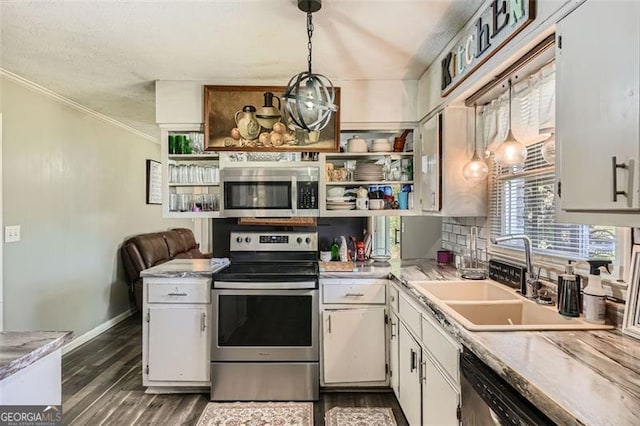 kitchen featuring dark hardwood / wood-style flooring, stainless steel appliances, sink, pendant lighting, and white cabinetry