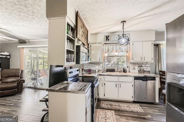 kitchen featuring pendant lighting, a textured ceiling, white cabinetry, and appliances with stainless steel finishes