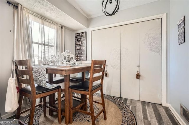 dining area with hardwood / wood-style floors