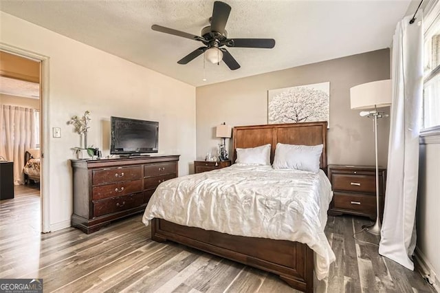 bedroom featuring ceiling fan and wood-type flooring