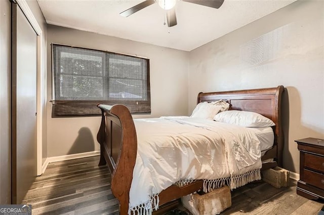 bedroom with dark hardwood / wood-style flooring, a closet, and ceiling fan