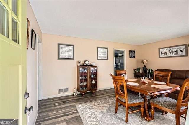 dining space with dark hardwood / wood-style floors