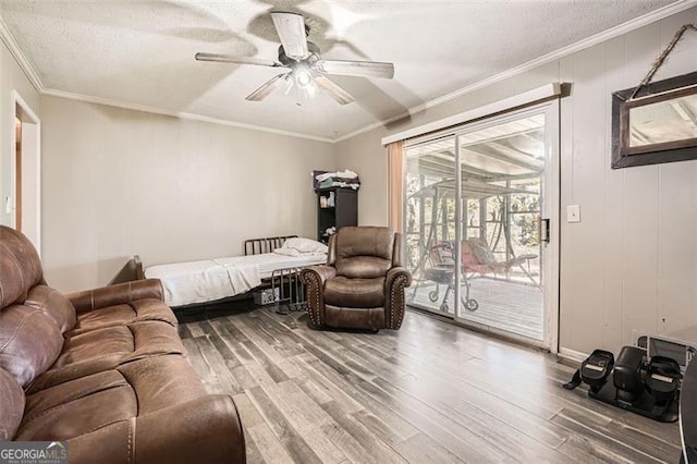 bedroom featuring wood-type flooring, access to outside, ceiling fan, and crown molding