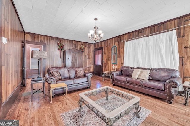 living room with light wood-type flooring and a notable chandelier