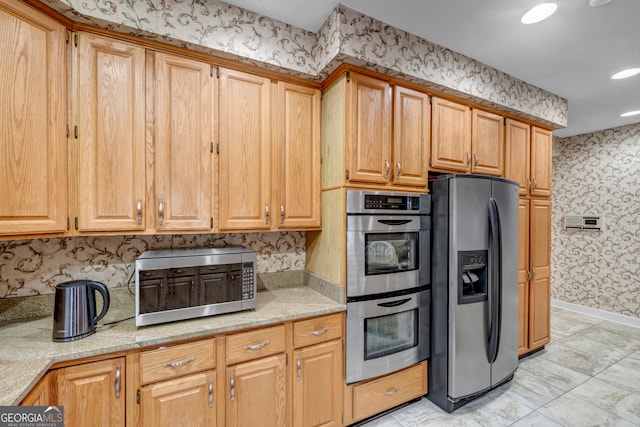 kitchen with light stone counters and stainless steel appliances