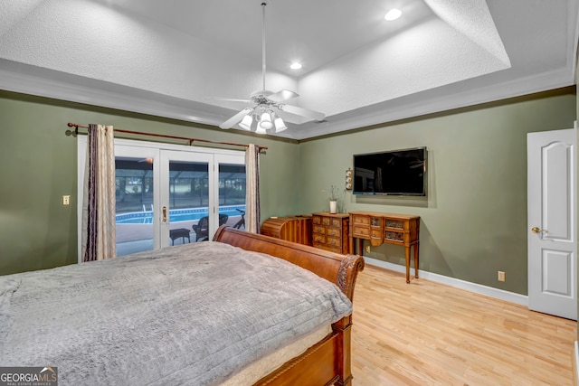 bedroom with light wood-type flooring, ornamental molding, a textured ceiling, access to outside, and ceiling fan