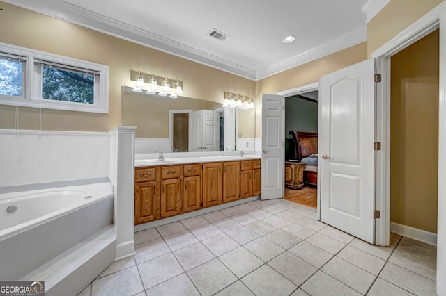 bathroom featuring tile patterned floors, vanity, a bath, and crown molding