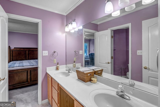 bathroom with vanity, ornamental molding, a textured ceiling, and toilet