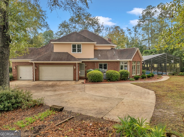 front of property with a garage and a lanai