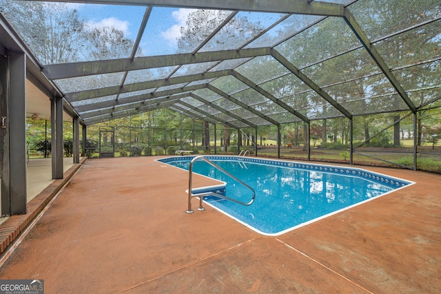 view of swimming pool with a lanai and a patio