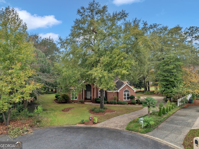 obstructed view of property featuring a front yard