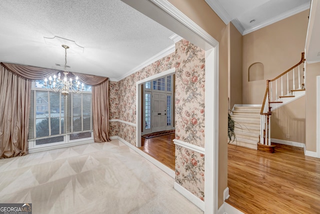 unfurnished dining area featuring a chandelier, hardwood / wood-style floors, a textured ceiling, and crown molding