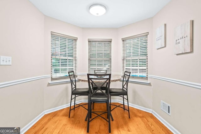 dining space with hardwood / wood-style flooring