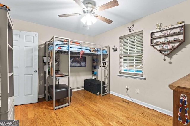 bedroom with light hardwood / wood-style floors and ceiling fan