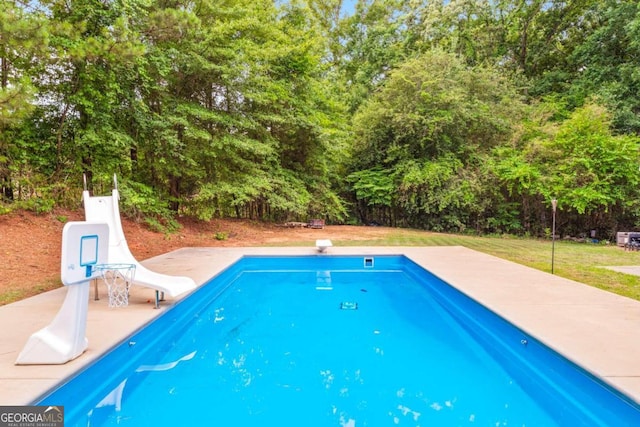 view of pool featuring a yard and a patio area