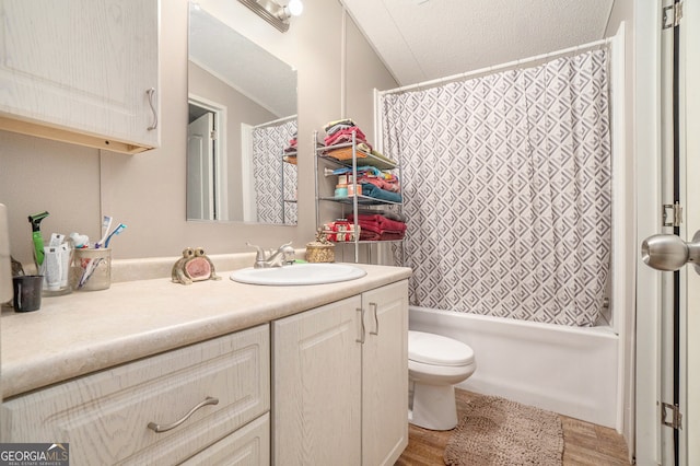 full bathroom featuring vanity, toilet, wood-type flooring, and a textured ceiling